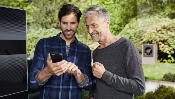 muž a instalatér se dívají na smartphone