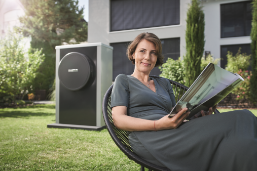 woman sitting in a chair with heat pump in garden